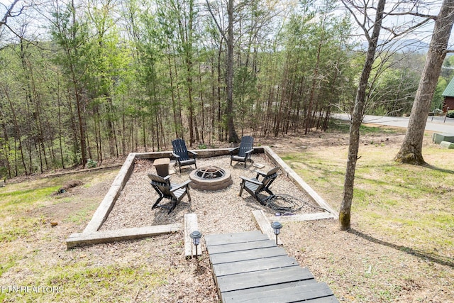 view of yard with a fire pit