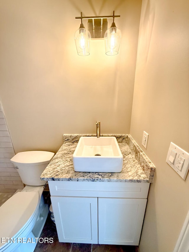 bathroom with vanity and toilet