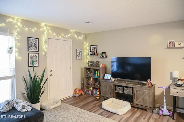 living room with visible vents and wood finished floors