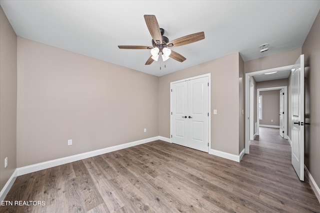 710 Westchester Dr, Crossville, TN 38558 - unfurnished bedroom featuring baseboards, wood finished floors, a closet, and a ceiling fan