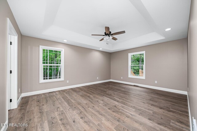 710 Westchester Dr, Crossville, TN 38558 - spare room featuring a tray ceiling, ceiling fan, wood finished floors, baseboards, and recessed lighting