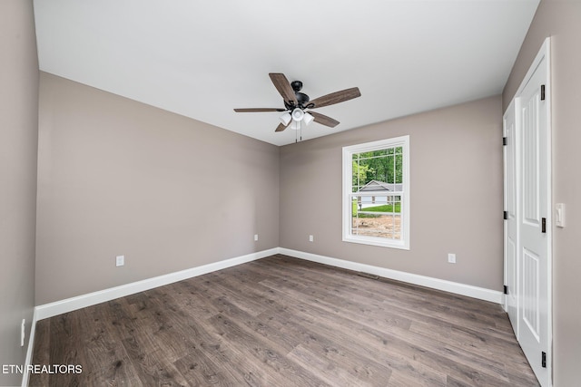 710 Westchester Dr, Crossville, TN 38558 - empty room featuring dark wood-type flooring, ceiling fan, and baseboards
