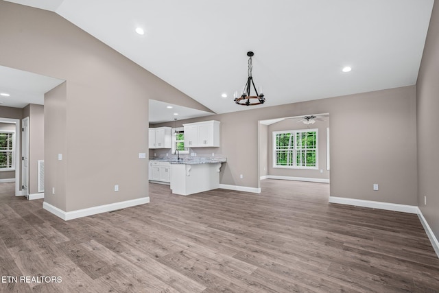 710 Westchester Dr, Crossville, TN 38558 - unfurnished living room with a chandelier, plenty of natural light, baseboards, a ceiling fan, and recessed lighting