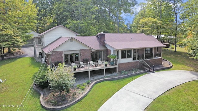 1517 Deerfield Way, Lafollette, TN 37766 - back of house featuring brick siding and a yard