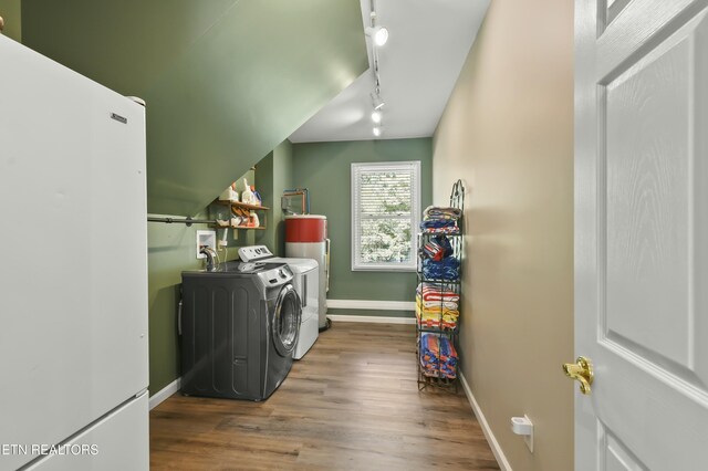 1517 Deerfield Way, Lafollette, TN 37766 - clothes washing area with baseboards, wood finished floors, independent washer and dryer, track lighting, and laundry area