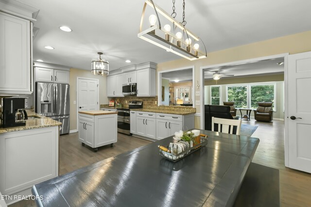 1517 Deerfield Way, Lafollette, TN 37766 - kitchen featuring butcher block countertops, white cabinets, decorative backsplash, stainless steel appliances, and dark wood finished floors