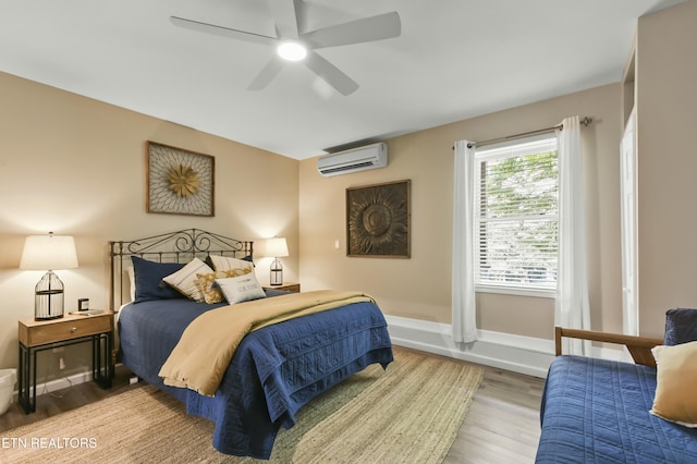 1517 Deerfield Way, Lafollette, TN 37766 - bedroom with a wall mounted AC, wood finished floors, baseboards, and ceiling fan