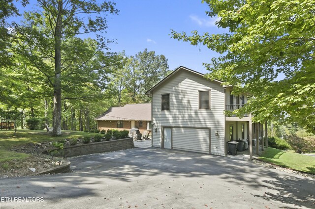 1517 Deerfield Way, Lafollette, TN 37766 - view of home's exterior featuring a garage, a balcony, and concrete driveway