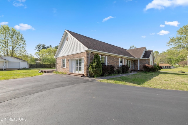 exterior space featuring brick siding and a yard