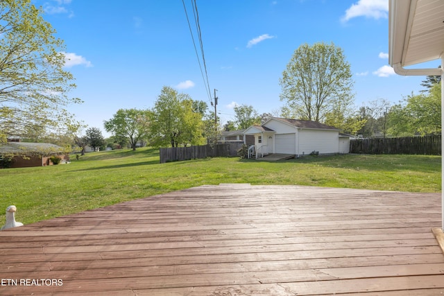 deck with fence, a yard, and a garage