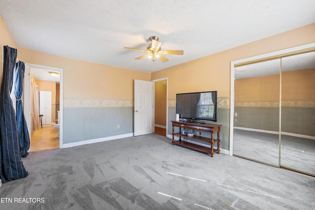 carpeted bedroom with baseboards, a ceiling fan, and a closet