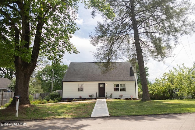 cape cod house with fence and a front yard