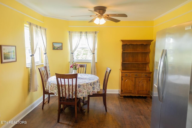 dining area with baseboards, ornamental molding, a ceiling fan, and dark wood finished floors
