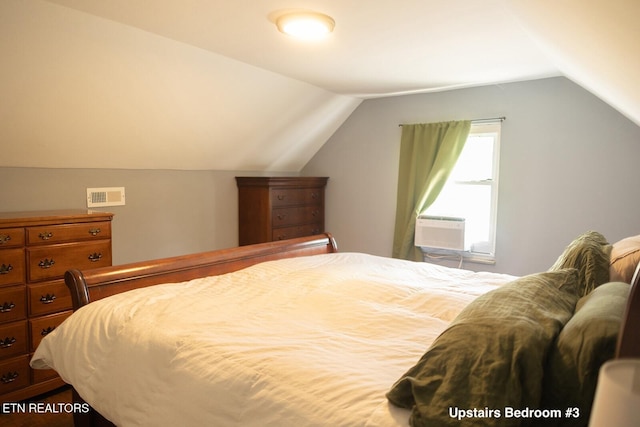 bedroom featuring cooling unit, vaulted ceiling, and visible vents