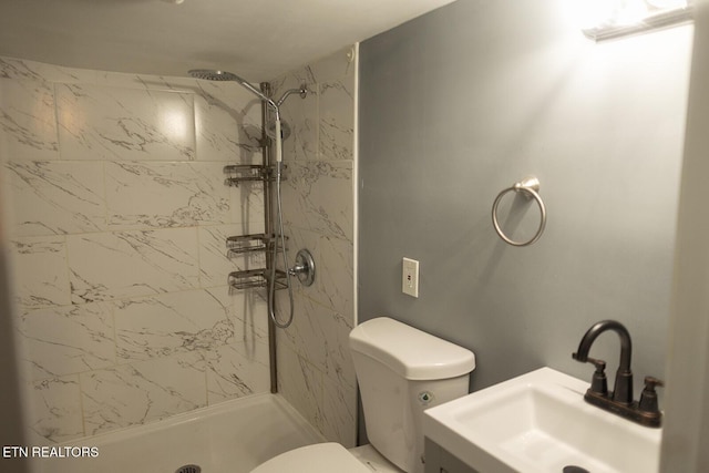 full bathroom featuring toilet, a sink, and a stall shower