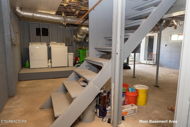 basement with washing machine and dryer and stairway