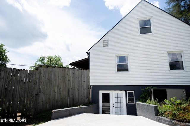 view of side of home with fence