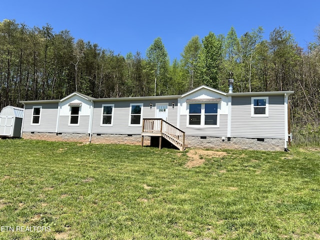 534 Wiggins Rd, Tellico Plains, TN 37385 - back of property with crawl space, a storage unit, an outdoor structure, and a yard