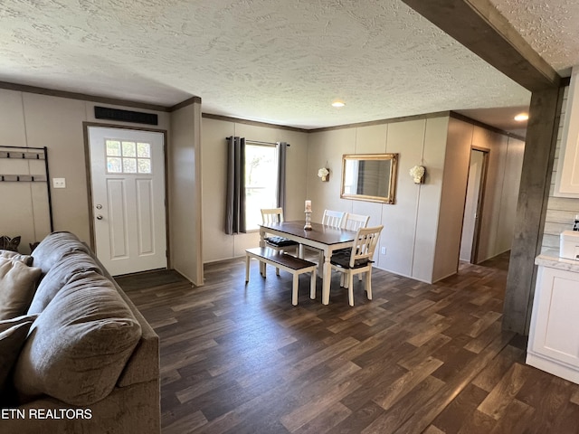 534 Wiggins Rd, Tellico Plains, TN 37385 - dining area featuring ornamental molding, dark wood-style flooring, and a textured ceiling