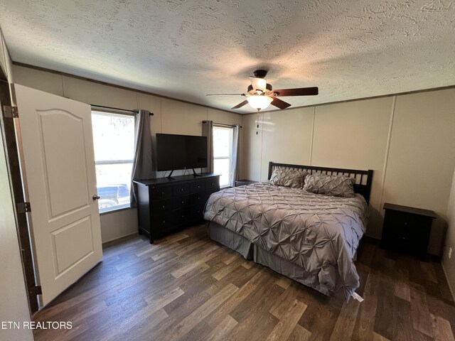 534 Wiggins Rd, Tellico Plains, TN 37385 - bedroom featuring a decorative wall, wood finished floors, and a textured ceiling