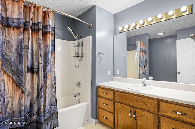 bathroom with shower / tub combo, a textured ceiling, and vanity