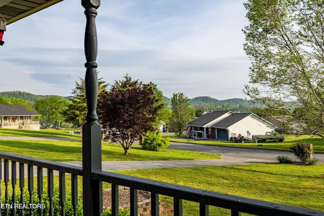 view of yard featuring a mountain view and fence
