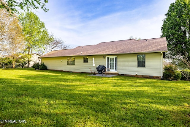 back of property featuring a lawn, a patio, and crawl space