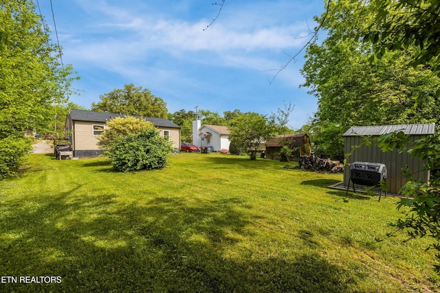 view of yard featuring a shed and an outbuilding