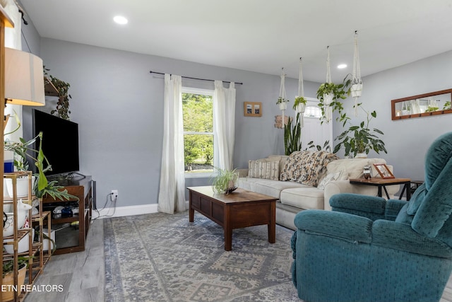 living area featuring recessed lighting, light wood-style flooring, and baseboards