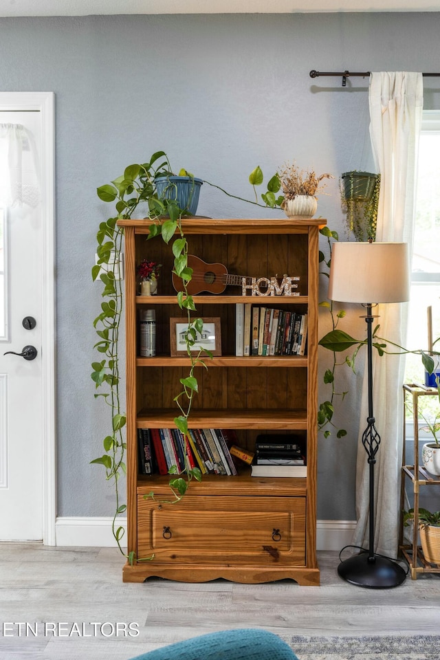 living area with wood finished floors and baseboards