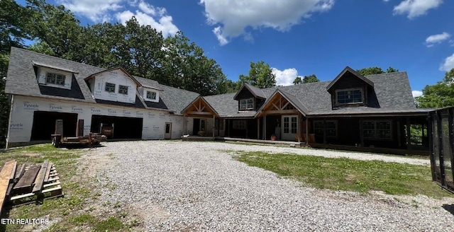 view of front facade featuring gravel driveway and a garage