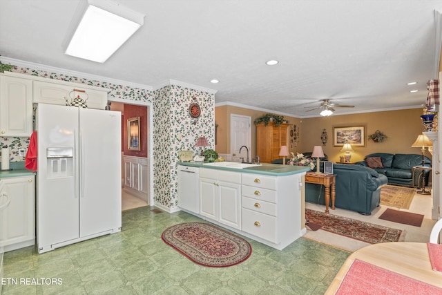kitchen featuring ceiling fan, white appliances, a peninsula, white cabinetry, and light floors