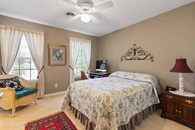 bedroom with light colored carpet, baseboards, visible vents, and multiple windows