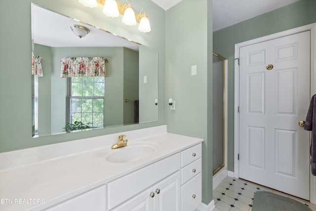 full bathroom with vanity, baseboards, and a stall shower