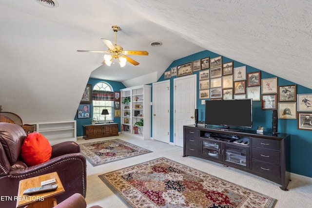 living area with visible vents, carpet, a ceiling fan, baseboards, and vaulted ceiling