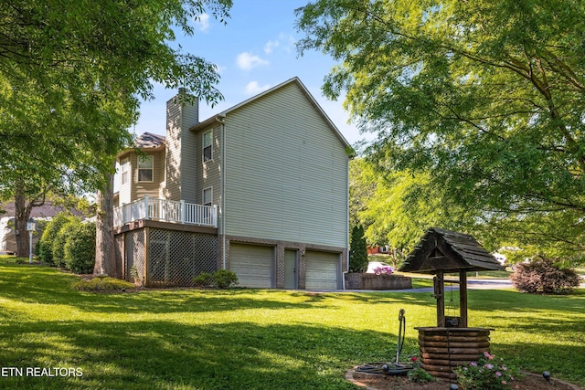 view of home's exterior featuring a lawn, a garage, a chimney, and a deck