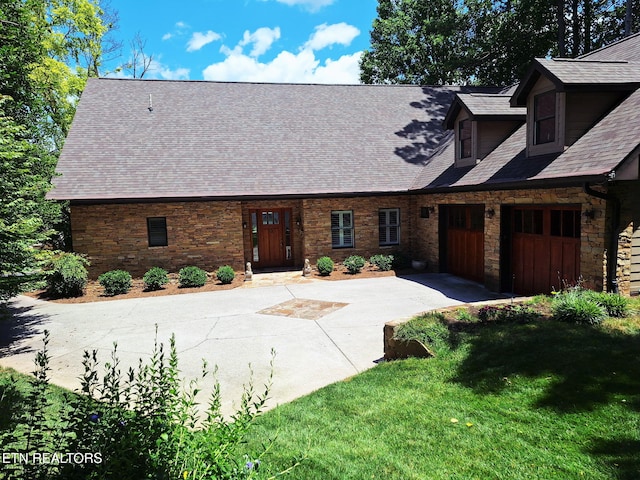 215 Dudala Way, Loudon, TN 37774 - view of front of property with concrete driveway, stone siding, a front lawn, roof with shingles, and an attached garage
