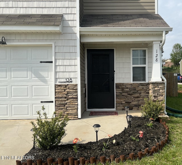 128 Waverly, Talbott, TN 37877 - entrance to property featuring a garage, stone siding, and a shingled roof
