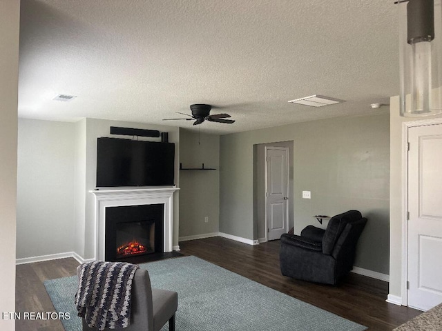 128 Waverly, Talbott, TN 37877 - living area with a fireplace with flush hearth, visible vents, dark wood-style floors, and ceiling fan