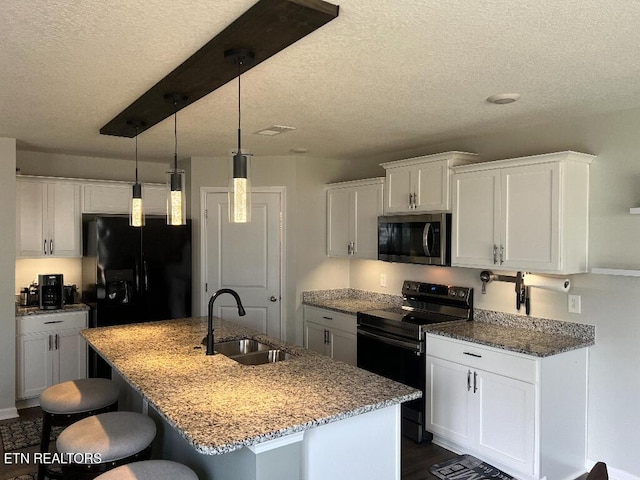 128 Waverly, Talbott, TN 37877 - kitchen with a sink, a textured ceiling, black appliances, a breakfast bar area, and white cabinets