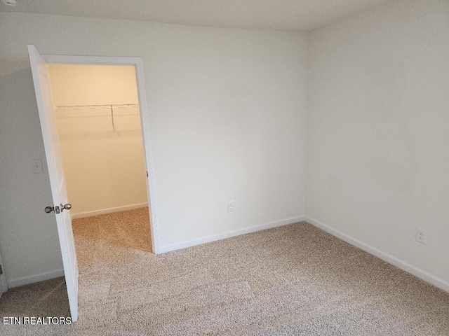 128 Waverly, Talbott, TN 37877 - unfurnished bedroom with a spacious closet, baseboards, and carpet floors