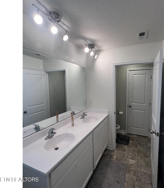 128 Waverly, Talbott, TN 37877 - bathroom featuring double vanity, toilet, and a sink