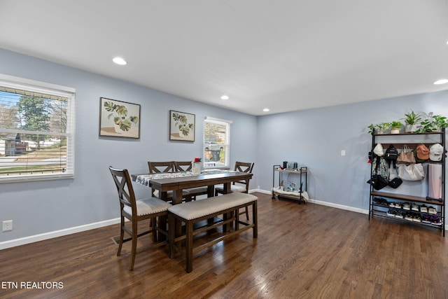 dining room with baseboards, wood finished floors, and recessed lighting