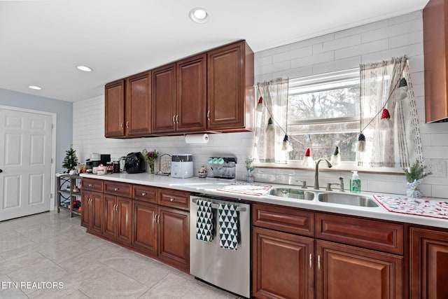 kitchen featuring a sink, dishwasher, light countertops, backsplash, and recessed lighting