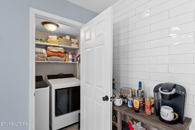 storage area featuring washing machine and dryer