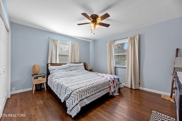 bedroom featuring baseboards, wood finished floors, a closet, and ceiling fan