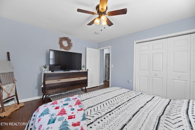 bedroom with wood finished floors, a closet, baseboards, and ceiling fan