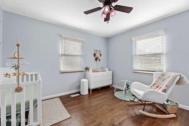living area with plenty of natural light, baseboards, wood finished floors, and ceiling fan