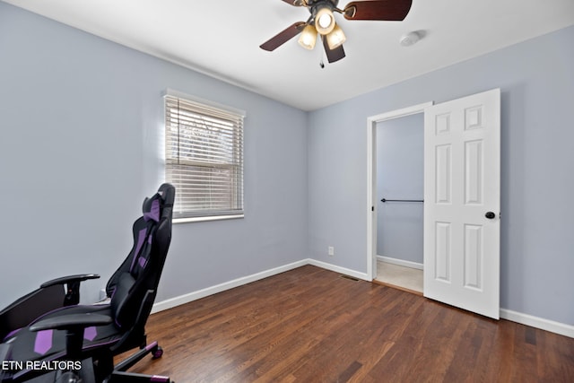 home office featuring visible vents, baseboards, wood finished floors, and ceiling fan