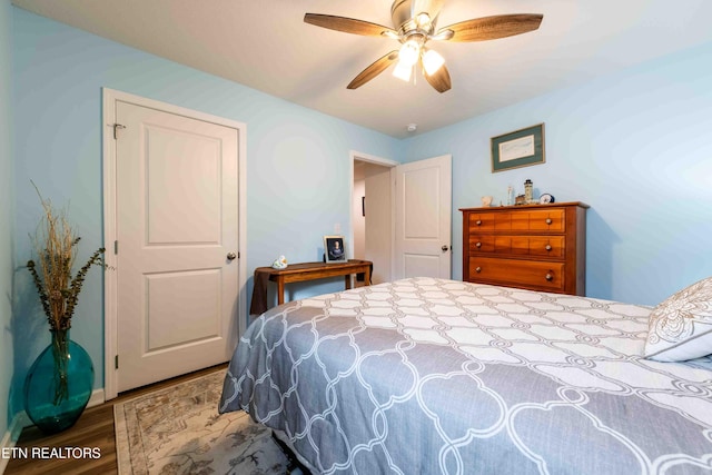 bedroom featuring a ceiling fan and wood finished floors
